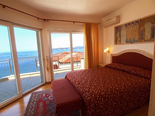 a bedroom with a bed and a view of the ocean at VILLA AURORA YourCroatiaHoliday in Savudrija