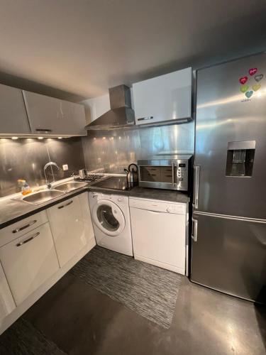 a kitchen with a stainless steel refrigerator and a dishwasher at BLB Loft Luxury House in Villenave-dʼOrnon