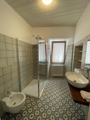 a bathroom with a toilet and a sink and a shower at CASA n 61 in Dervio