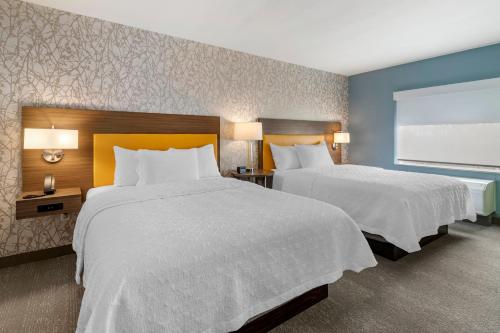 a hotel room with two beds and a window at Home2 Suites by Hilton Bangor in Bangor