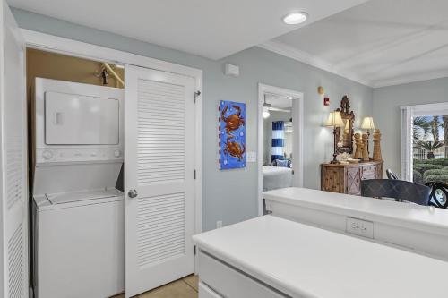 a white kitchen with a sink and a dishwasher at Palm Beach Resort 15B in Gulf Shores