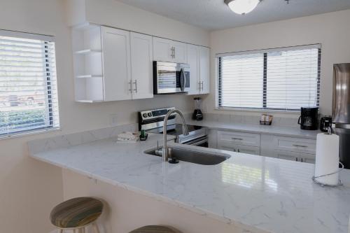 a kitchen with white cabinets and a sink at Legacy Vacation Resorts - Palm Coast in Palm Coast