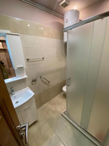 a bathroom with a shower and a sink at Hotel Berr in Sarajevo