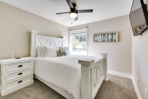 a bedroom with a white bed and a window at Charming Coastal Home 6 Mi to Choctawhatchee Bay! in Niceville