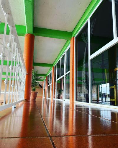 an empty hallway of a building with large windows at Cabañas y Habitaciones El Malecón in Zirahuén