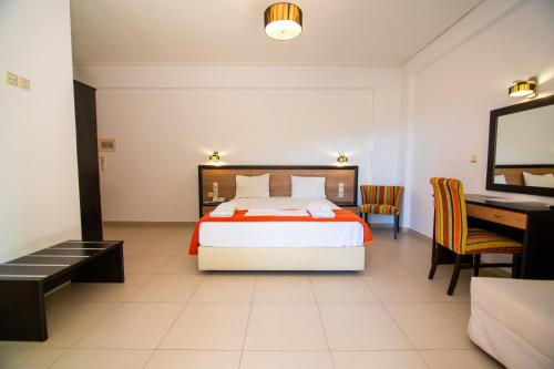 a hotel room with a bed and a desk at Riviera Perdika Hotel in Perdika