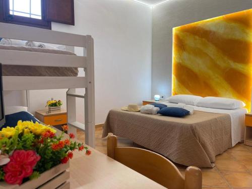 a bedroom with a bed and a bunk bed at "L'Oasi di Favignana" Room and Charme in Favignana