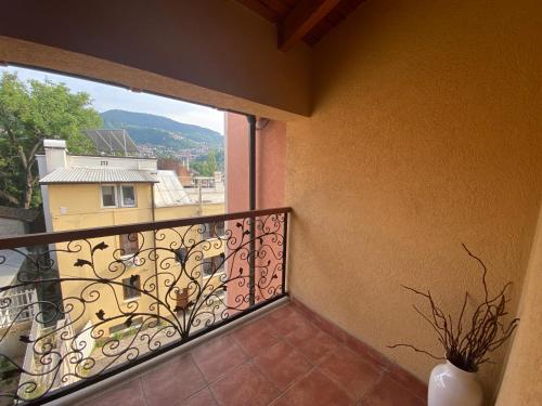 a balcony with a window with a vase on it at Hotel Berr in Sarajevo
