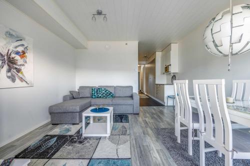 a living room with a couch and a table at Starvillas B 202 Sisältää loppusiivouksen in Kalajoki