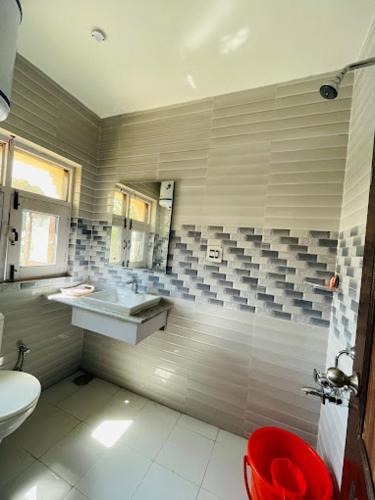 a bathroom with a shower and a sink and a toilet at Himalayan Haven in Srinagar