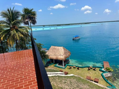 a view of a body of water with a boat at bacalar My Love Front Laguna in Bacalar