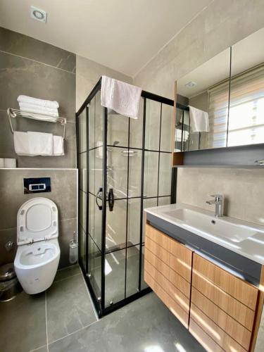 a bathroom with a shower and a toilet and a sink at Necip Bey Konağı in Antalya