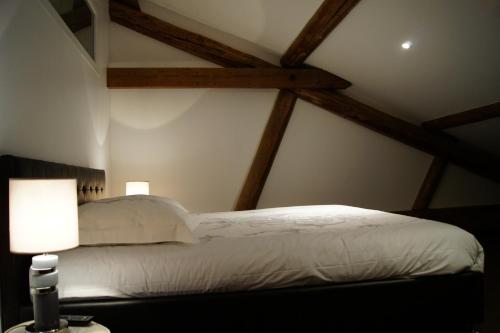 a bedroom with a white bed and two lamps at Ferme Sainte Marie in Rémilly