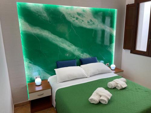 a bedroom with a bed with two towels on it at "L'Oasi di Favignana" Room and Charme in Favignana