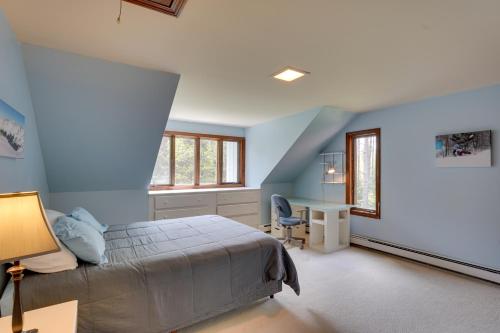 a bedroom with blue walls and a bed and a desk at Mendon Home with Hot Tub, Fire Pit and Near Skiing! in Mendon