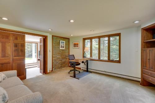 a living room with a couch and a desk at Mendon Home with Hot Tub, Fire Pit and Near Skiing! in Mendon