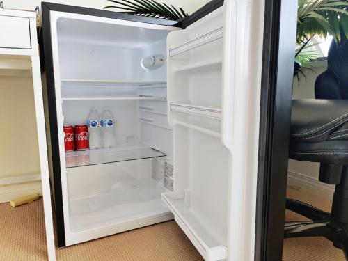 a refrigerator with its door open in a room at Waterfront Room2 with Private Bath near Marina in Gibsons