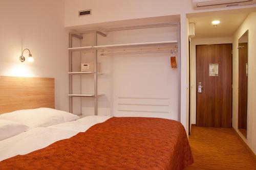 Ένα ή περισσότερα κρεβάτια σε δωμάτιο στο Hotel Ambiance