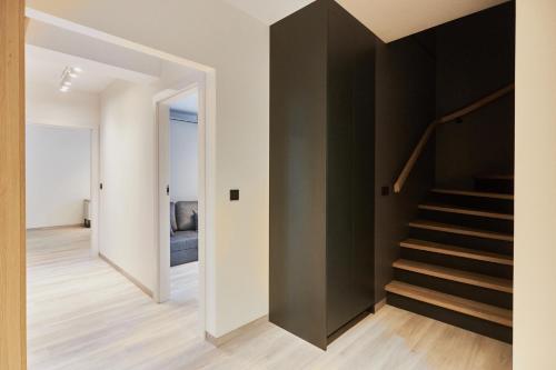 a staircase in a house with a black wall at Apartamenty Świnoujście - Matejki 1b in Świnoujście