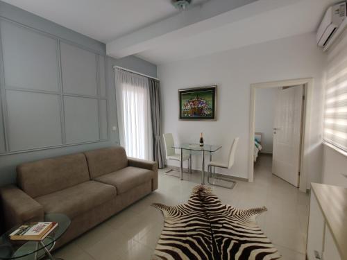 a living room with a couch and a zebra rug at Montesun Residence in Herceg-Novi