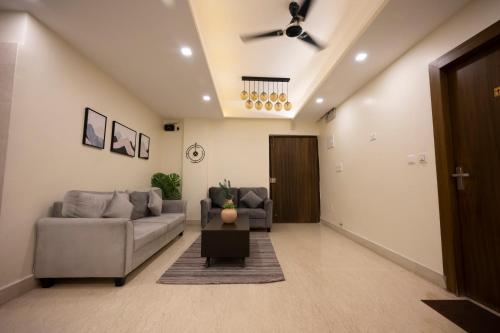 a living room with a couch and a table at Lakeside Suites in Kolkata