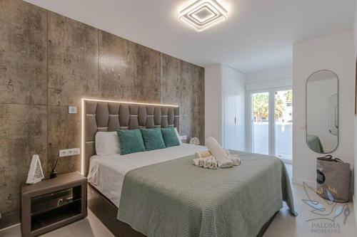 a bedroom with a large bed and a mirror at Puerto Marina Luxury 2BDR Apartment with Sea View in Benalmádena