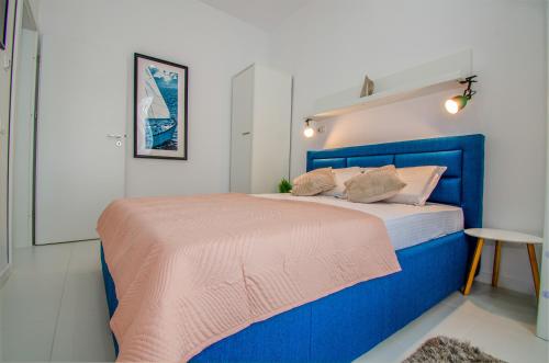 a blue bed in a small room with a table at Forest by the sea in Jupiter