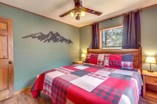 a bedroom with a bed with a checkered blanket at Mtn-View Hilltop Hideaway with Deck in Show Low in Show Low