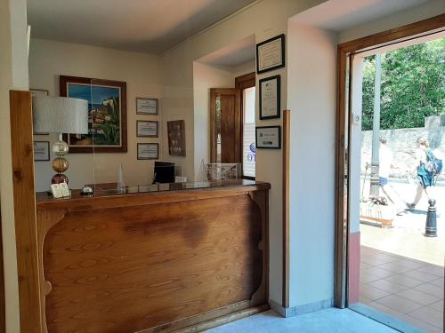a home office with a wooden reception counter at Hotel Alvaro frente Palacio-Museo Selgas in Cudillero