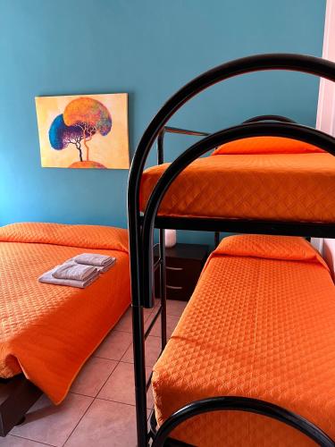 a room with two bunk beds and a painting on the wall at Waterfront Gallipoli 150 mt dal mare in Gallipoli