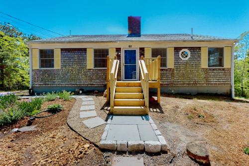 a house with a set of stairs in front of it at Tall Pines in Wellfleet