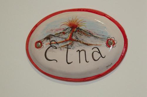 a red plate with the word garma on it at Duomo Bed & Breakfast in Catania