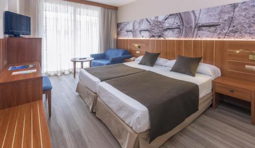 
a bedroom with a large bed and a large window at GHT Aquarium & Spa in Lloret de Mar
