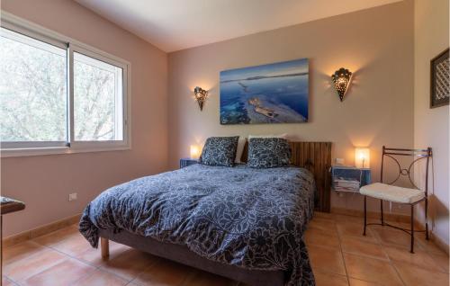 a bedroom with a bed and two windows at Beautiful Home In Balaruc-les-bains With Wifi in Balaruc-les-Bains