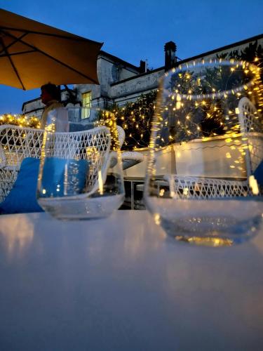a table with two chairs and lights on it at Palazzo Cappuccini Art Relais in Naples