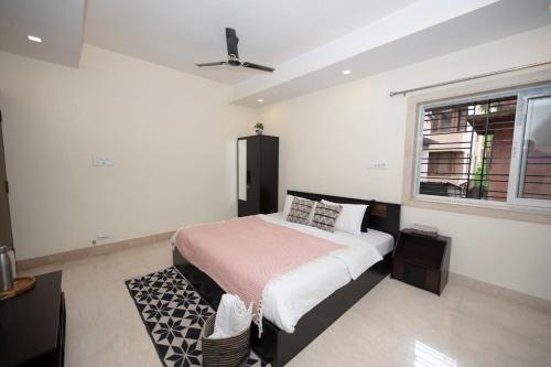 a bedroom with a bed and a window at Lakeside Suites in Kolkata