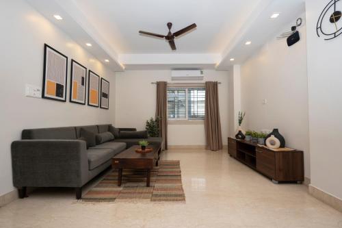 a living room with a couch and a table at Lakeside Suites in Kolkata