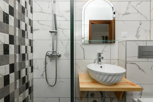 a bathroom with a white sink and a shower at Maria's House in Potamiá