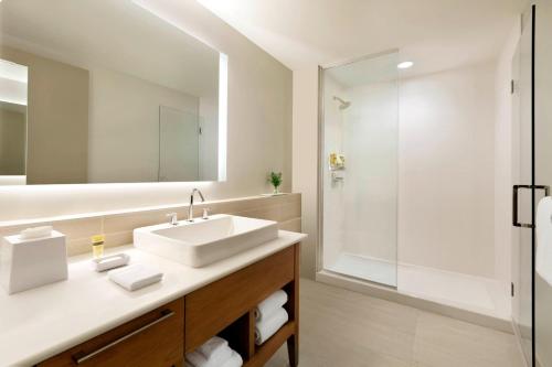 a bathroom with a sink and a shower at Element Dallas Love Field in Dallas