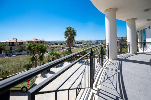 a balcony with a view of a city at Villa Floyd Charming Rooms B&B in Pachino