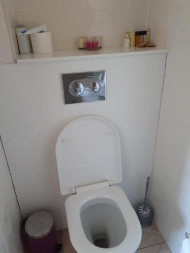 a small bathroom with a white toilet with a sink at cherry in Galway