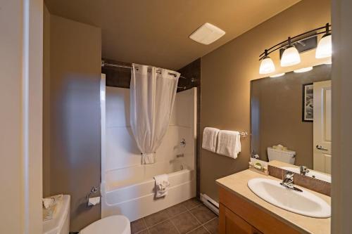a bathroom with a sink and a shower and a toilet at Sooke Harbour Resort & Marina in Sooke