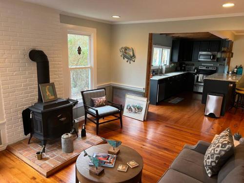 a living room with a stove and a kitchen at The Happy Place in Tilghman Island