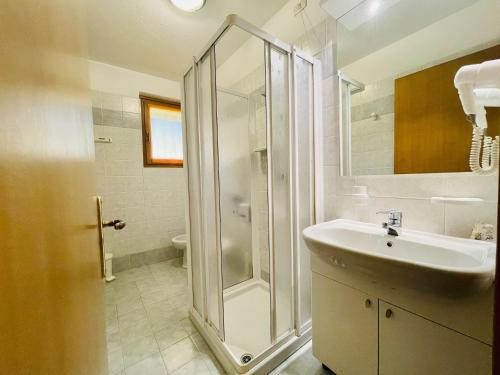 uma casa de banho com um chuveiro e um lavatório. em Elga Residence - Relax in Alta Valtellina - Bormio em Valdisotto