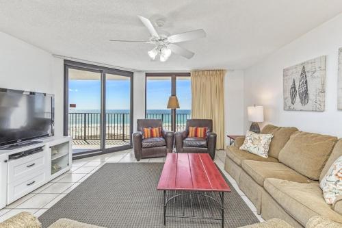 a living room with a couch and a flat screen tv at Phoenix 6 Unit 813 in Orange Beach