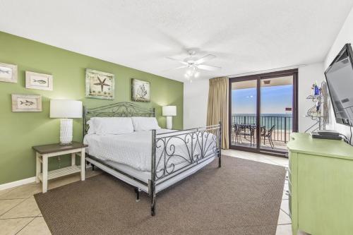 a bedroom with a bed and a view of the ocean at Phoenix 6 Unit 813 in Orange Beach