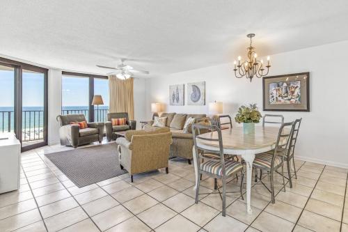 a living room with a table and chairs and a couch at Phoenix 6 Unit 813 in Orange Beach
