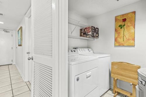 a white laundry room with a washing machine in it at Phoenix 6 Unit 813 in Orange Beach