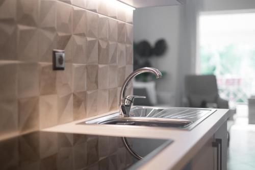 a kitchen counter with a sink in a kitchen at Charming Appt in Preveza