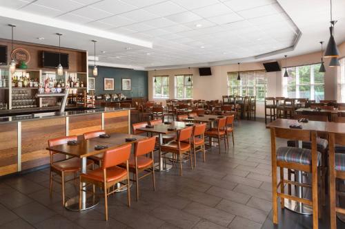 a restaurant with tables and chairs and a bar at Four Points by Sheraton Surrey in Surrey